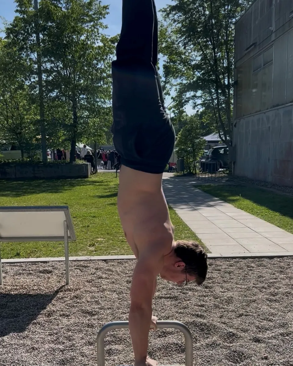 Fabian im Handstand auf Parallettes im Park
